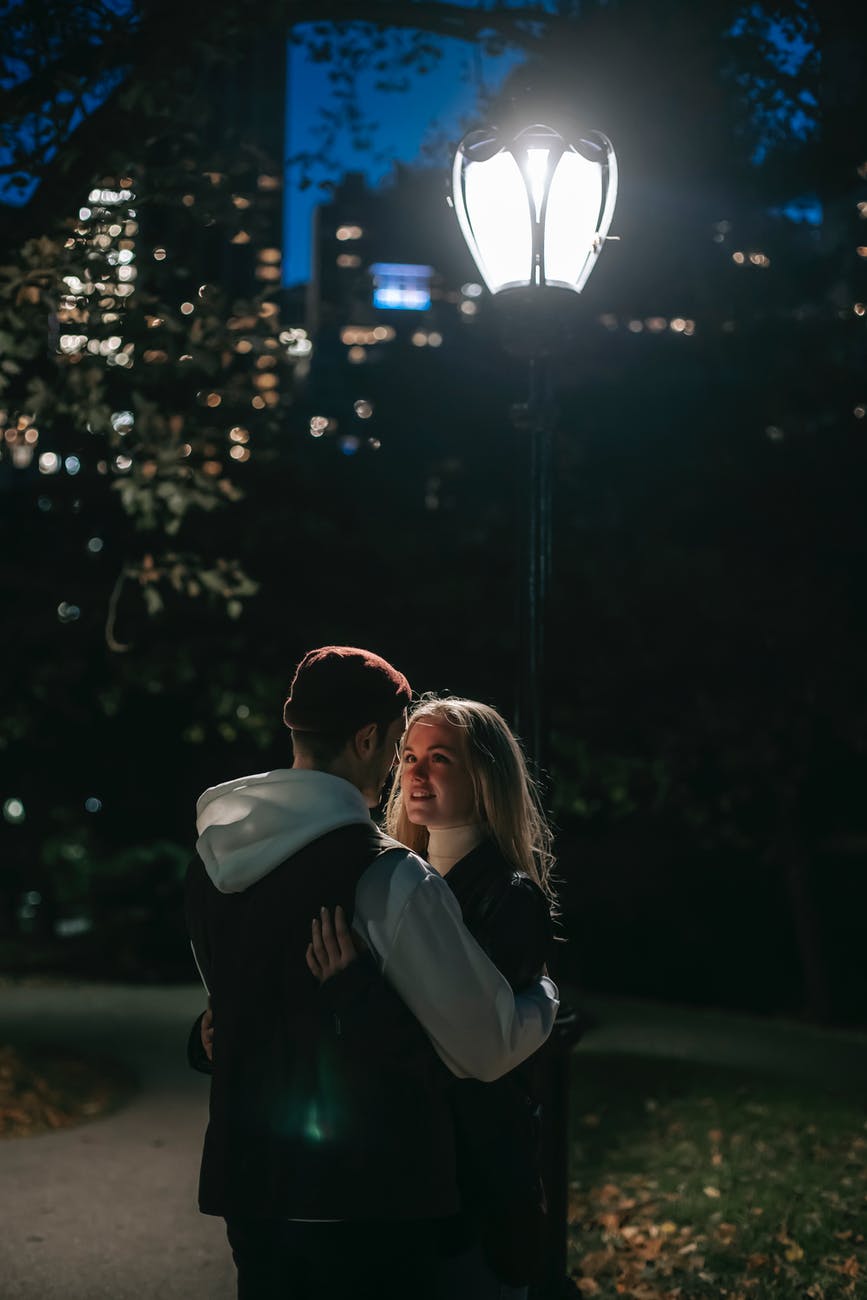 romantic couple hugging in park at night